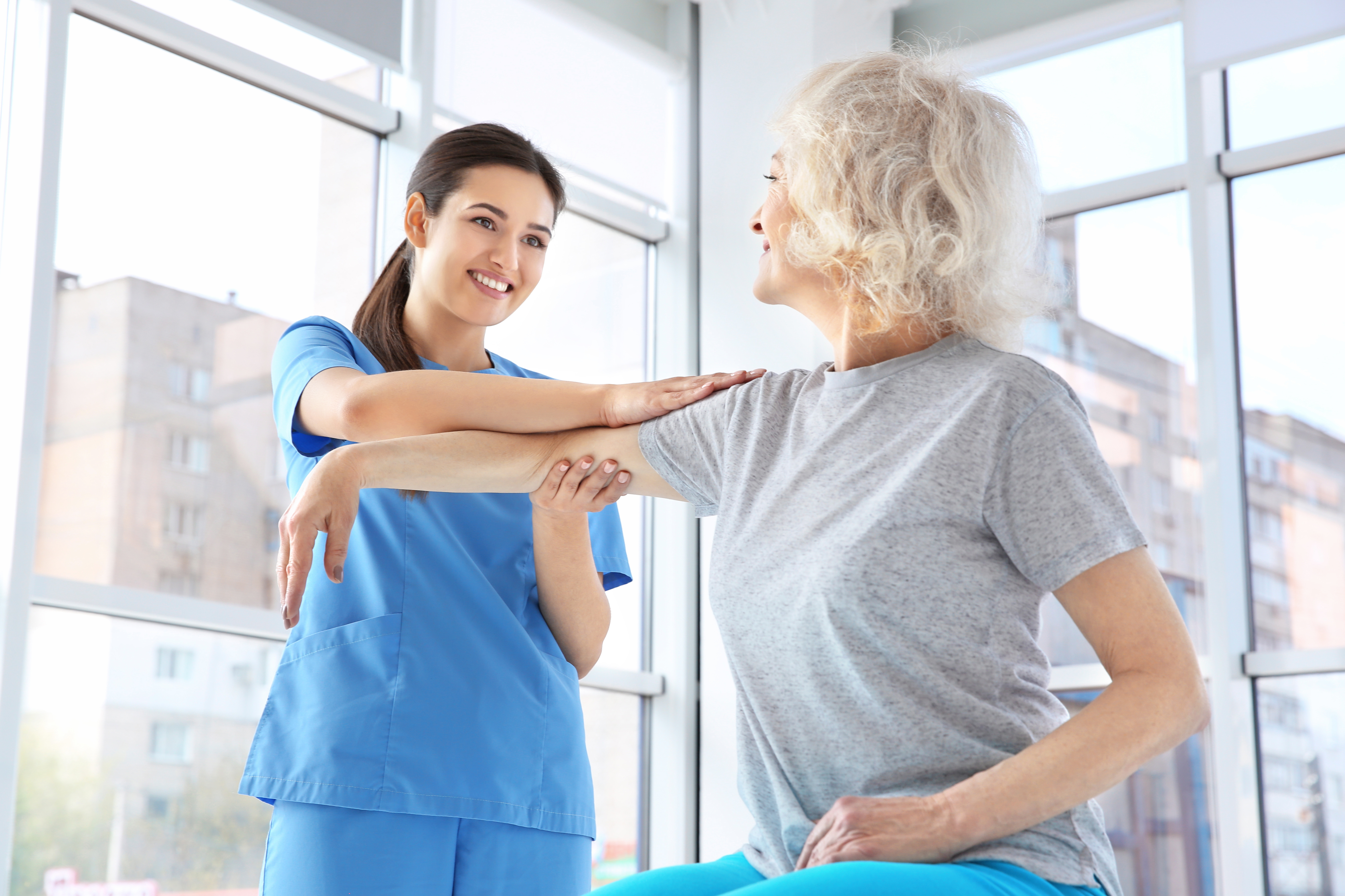 physical therapist working with elderly patient